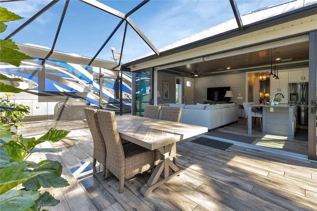 wooden terrace with a patio and ceiling fan