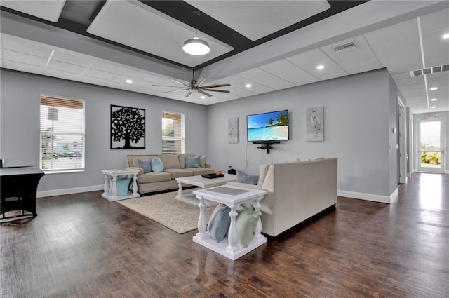 living room with ceiling fan, plenty of natural light, and dark wood-type flooring