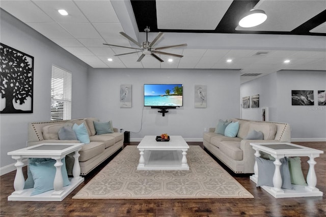 living room featuring ceiling fan and dark wood-type flooring