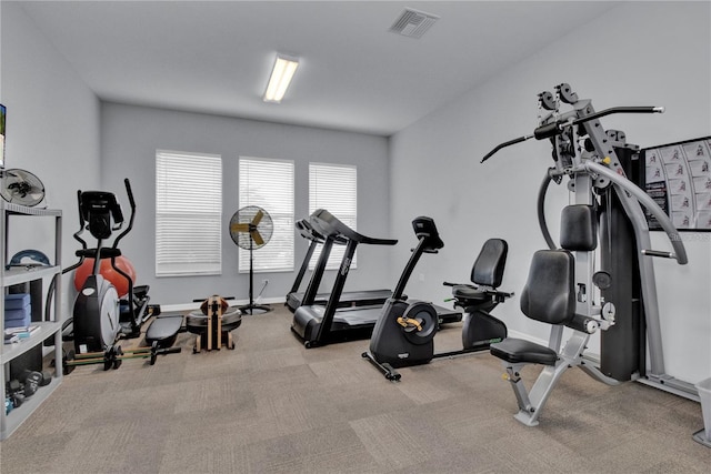 exercise room with light colored carpet