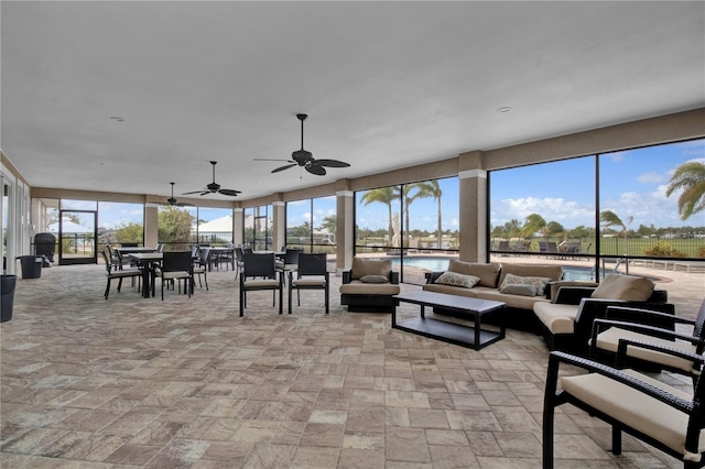 interior space with ceiling fan