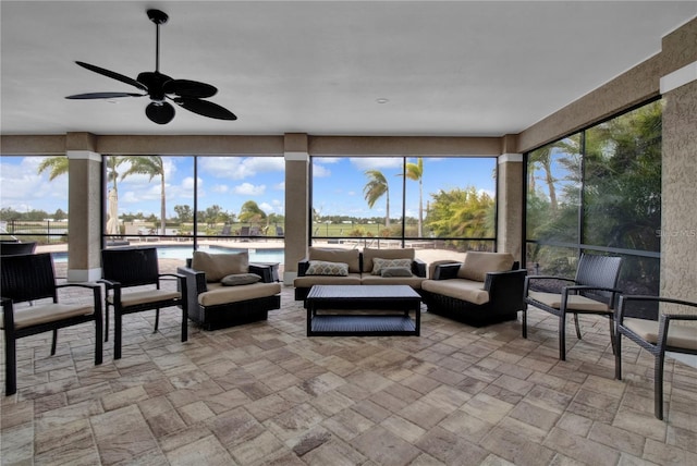 sunroom / solarium featuring ceiling fan