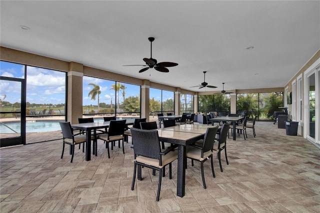 sunroom featuring ceiling fan