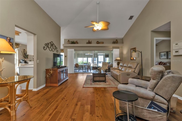 living room featuring ceiling fan, high vaulted ceiling, and hardwood / wood-style flooring