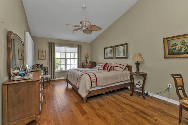 bedroom featuring ceiling fan, hardwood / wood-style floors, and high vaulted ceiling