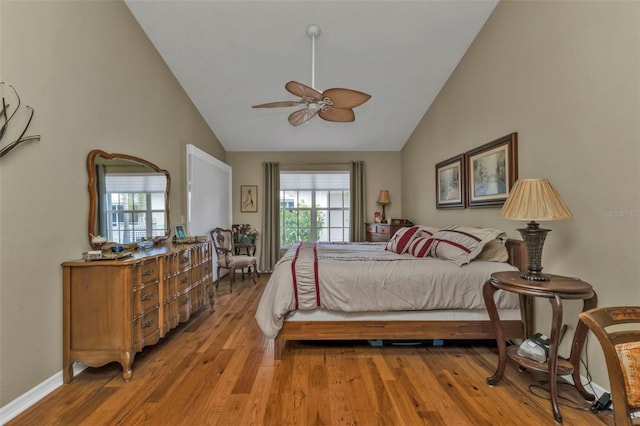 bedroom featuring hardwood / wood-style flooring, ceiling fan, and high vaulted ceiling