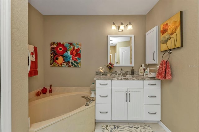 bathroom with a tub to relax in, tile patterned flooring, and vanity