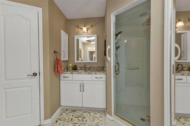 bathroom with tile patterned flooring, vanity, and a shower with shower door