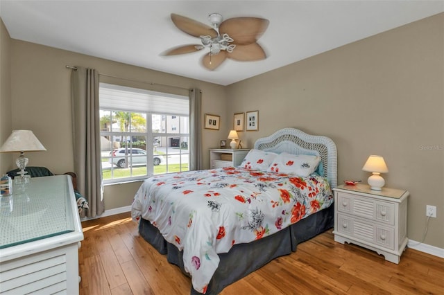 bedroom with ceiling fan and light hardwood / wood-style flooring