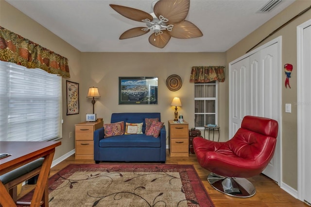 living area featuring ceiling fan and hardwood / wood-style floors