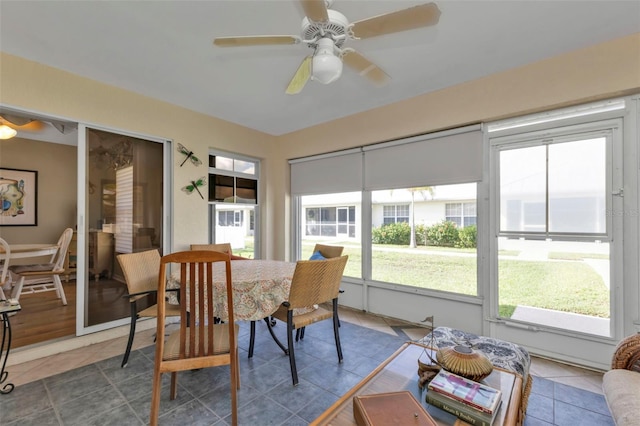 sunroom featuring ceiling fan