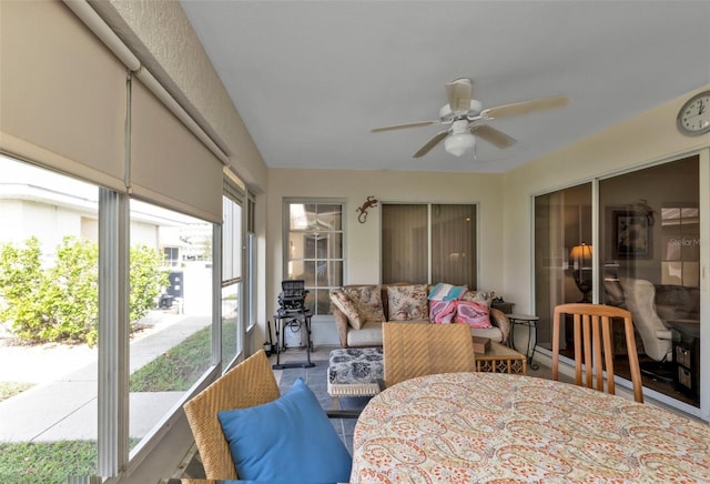 sunroom / solarium featuring plenty of natural light and ceiling fan