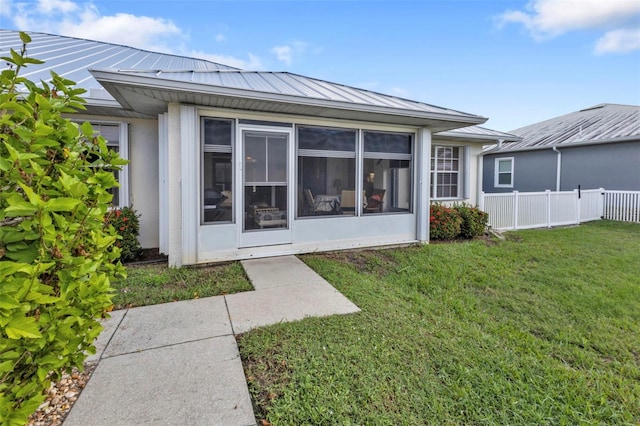 rear view of property featuring a yard