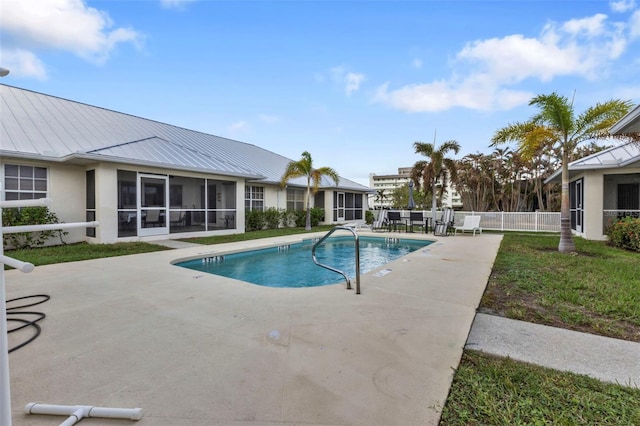 view of swimming pool featuring a sunroom and a patio