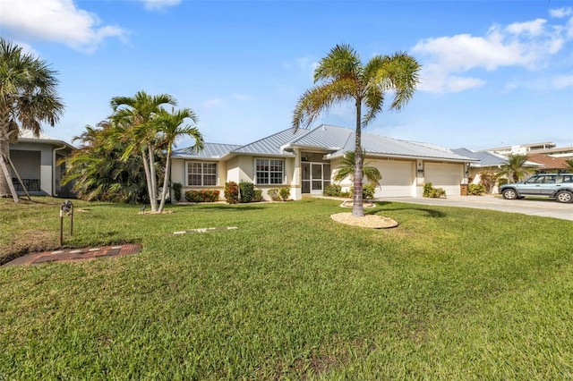 ranch-style house featuring a front lawn and a garage