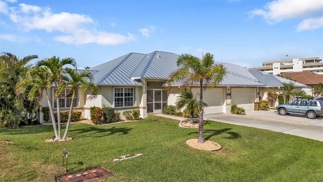 view of front of home with a front yard and a garage