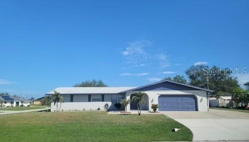 ranch-style house with a front yard and a garage