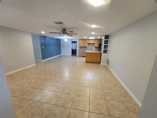 unfurnished living room with ceiling fan and light tile patterned floors