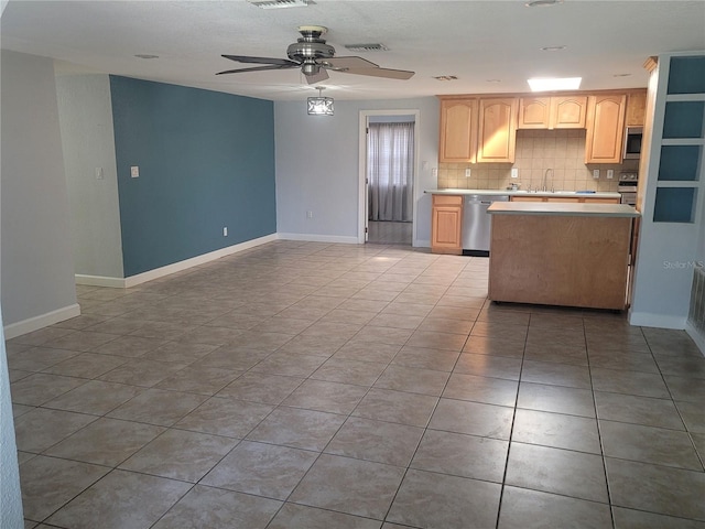 kitchen with ceiling fan, sink, stainless steel dishwasher, backsplash, and light brown cabinetry