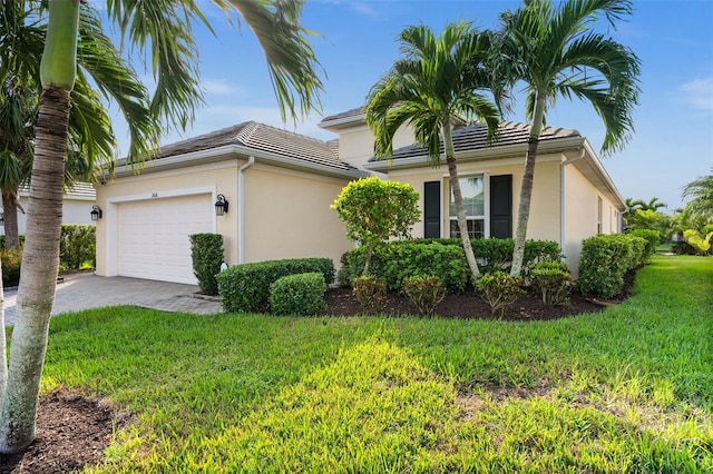 view of front of house featuring a garage and a front lawn