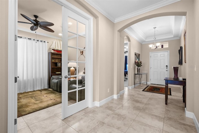 entryway with crown molding, light carpet, and ceiling fan with notable chandelier