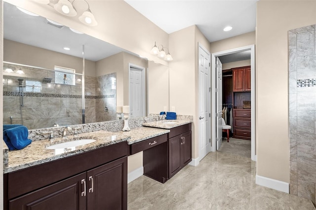 bathroom with vanity and tiled shower