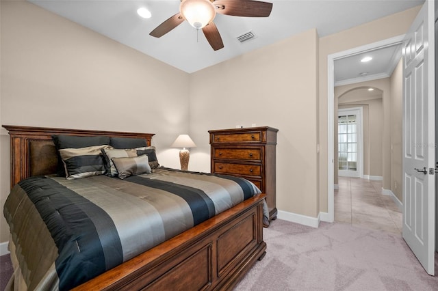 carpeted bedroom featuring ceiling fan and ornamental molding