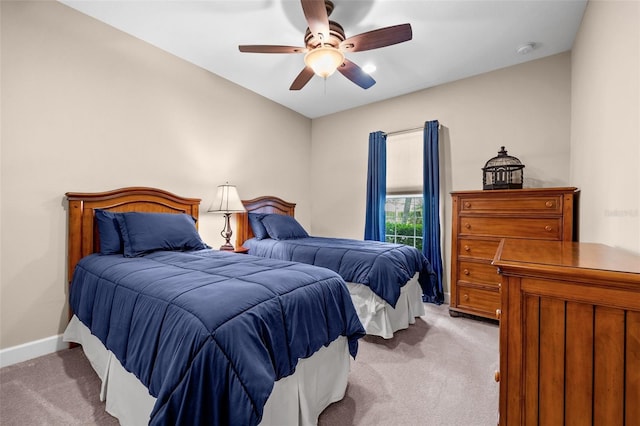 bedroom featuring ceiling fan and light carpet