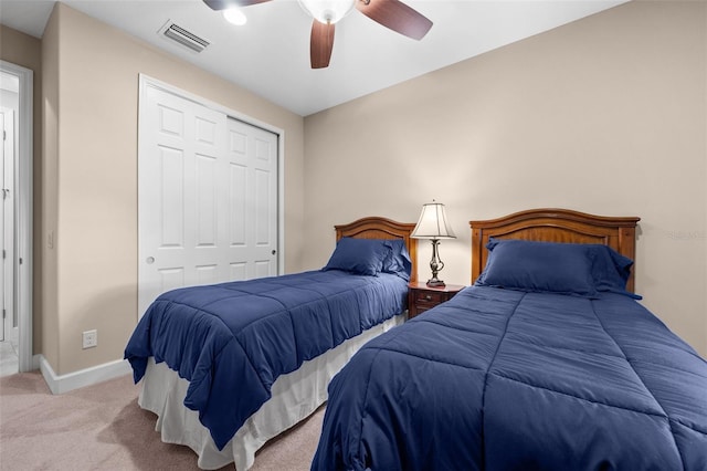 bedroom with light colored carpet, a closet, and ceiling fan