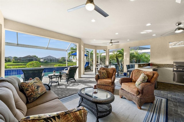 sunroom with a wealth of natural light, a swimming pool, and ceiling fan