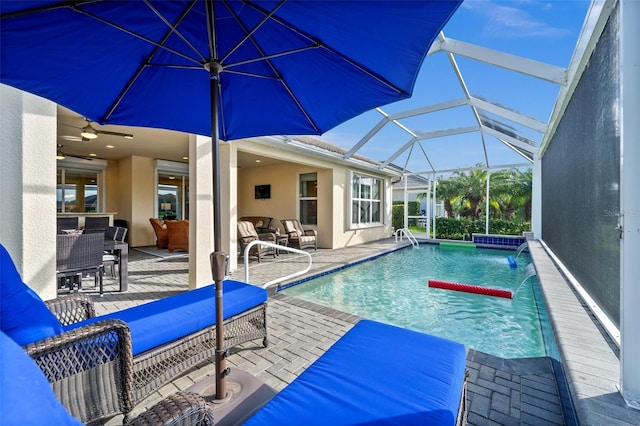 view of swimming pool featuring a patio area, pool water feature, ceiling fan, and an outdoor hangout area