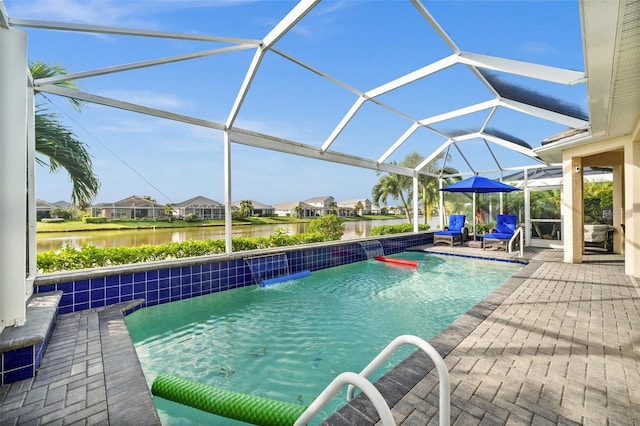 view of pool with pool water feature, glass enclosure, a water view, and a patio