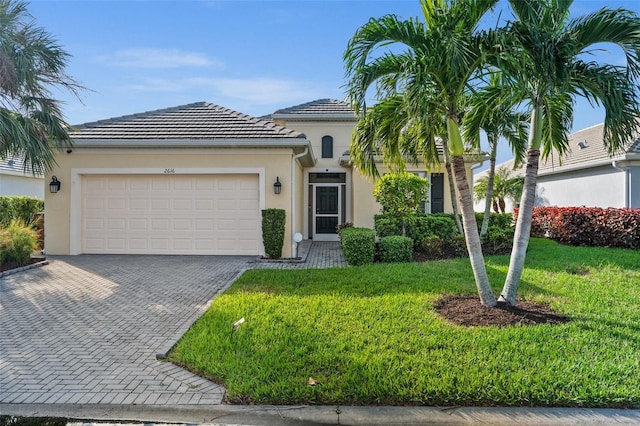 view of front of house with a garage and a front lawn