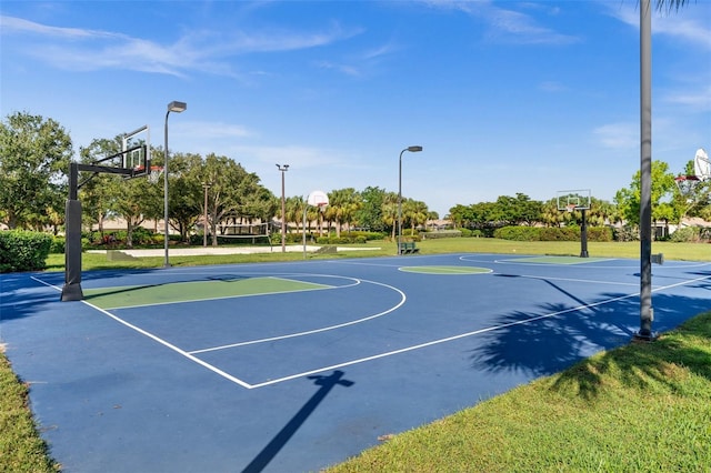 view of sport court featuring a lawn