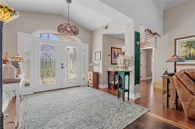 entrance foyer featuring hardwood / wood-style floors, high vaulted ceiling, and french doors