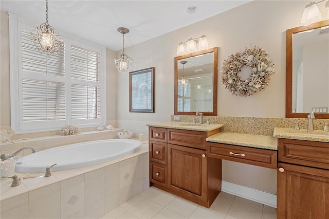 bathroom featuring tile patterned flooring, vanity, plus walk in shower, and a chandelier