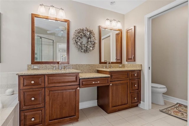 bathroom featuring tile patterned flooring, vanity, toilet, and a shower with shower door