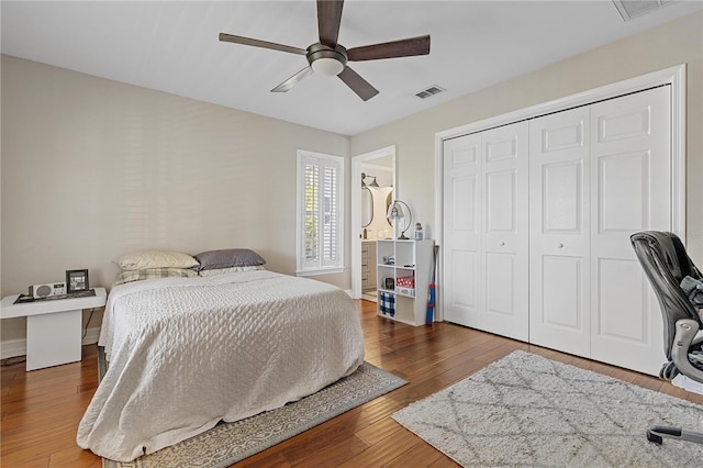 bedroom with hardwood / wood-style floors, a closet, and ceiling fan