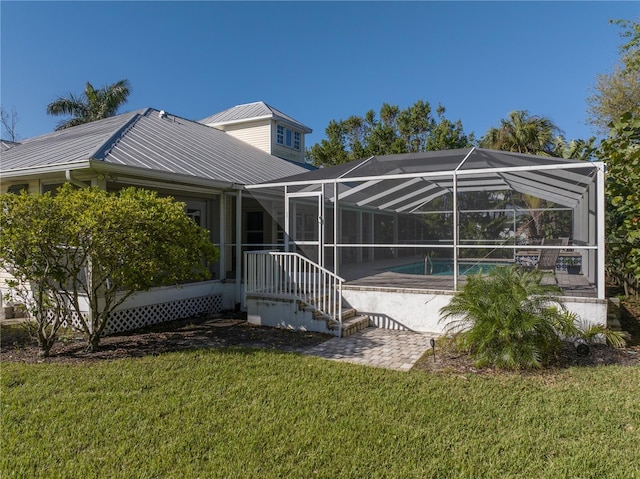 12510 Coconut Creek Ct, Fort Myers, FL 33908 - rear view of property with a lawn, metal roof, an outdoor pool, a patio, and a lanai