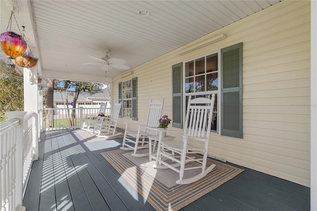 wooden deck with a porch and ceiling fan