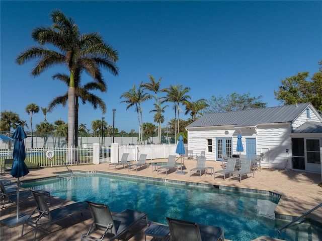 12510 Coconut Creek Ct, Fort Myers, FL 33908 - community pool with french doors, a patio area, and fence