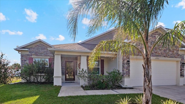 view of front of property with a garage and a front lawn