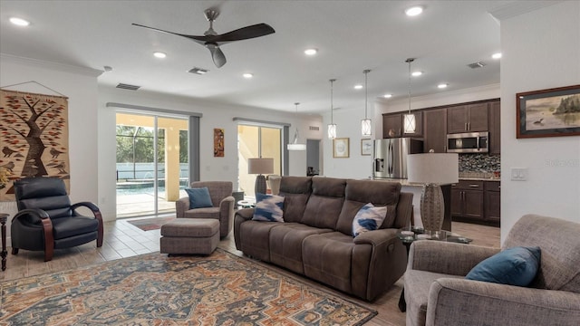 living room with ceiling fan, light wood-type flooring, and ornamental molding