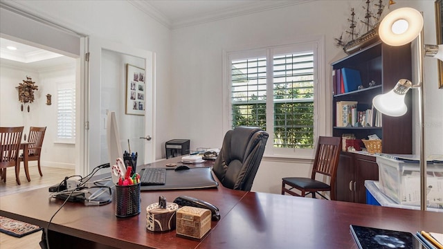 office featuring hardwood / wood-style floors, ornamental molding, and a healthy amount of sunlight