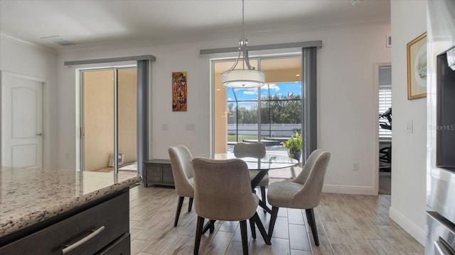 dining area featuring light hardwood / wood-style floors and crown molding