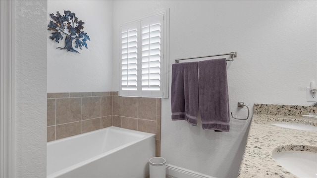 bathroom with a bath and vanity