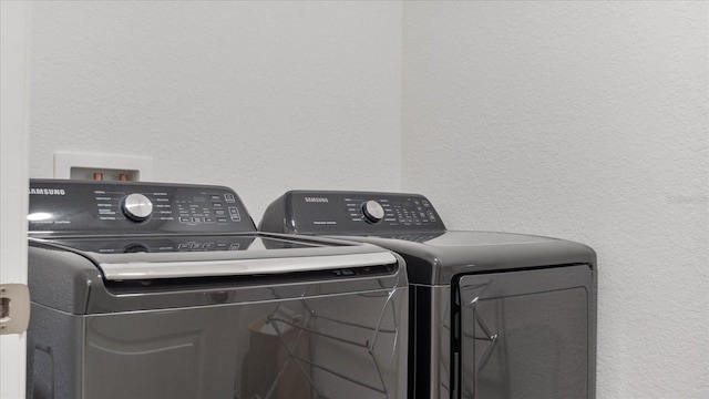 laundry area with independent washer and dryer