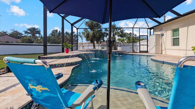 view of pool with pool water feature, glass enclosure, a hot tub, and a patio area