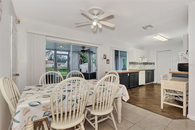 tiled dining room featuring ceiling fan