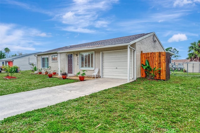 ranch-style house with a garage and a front lawn